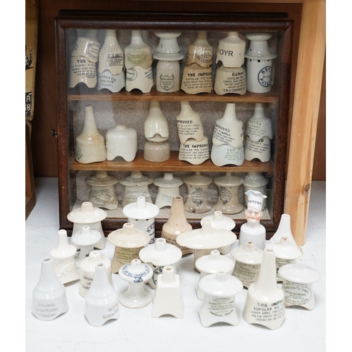 1271 - Approximately fifty assorted Victorian pottery pie funnels, some contained within a mahogany display... 