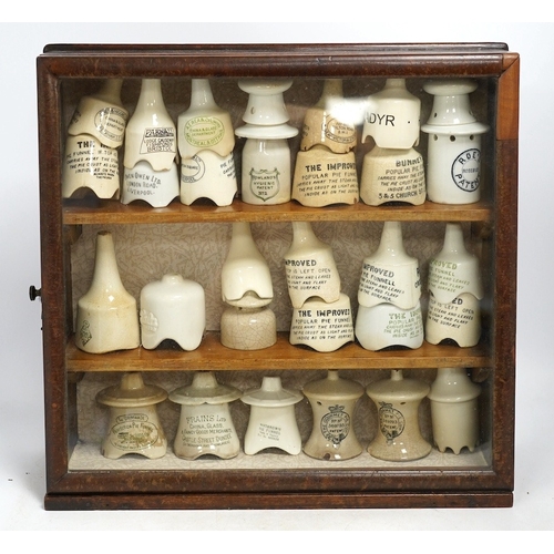 1271 - Approximately fifty assorted Victorian pottery pie funnels, some contained within a mahogany display... 