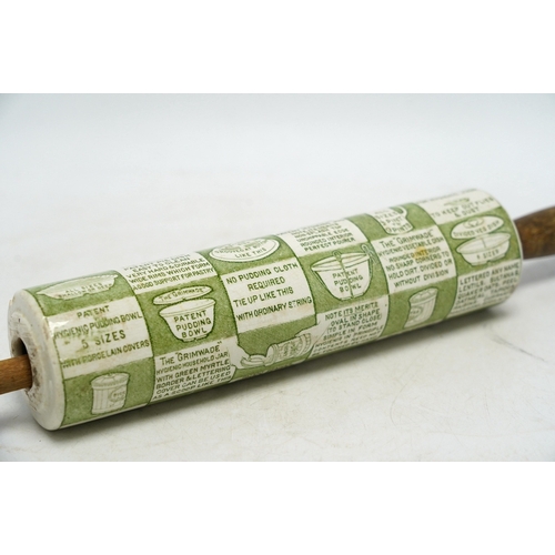 1287 - An early 20th century Grimwades green printed earthenware promotional rolling pin, 47cm wide. Condit... 