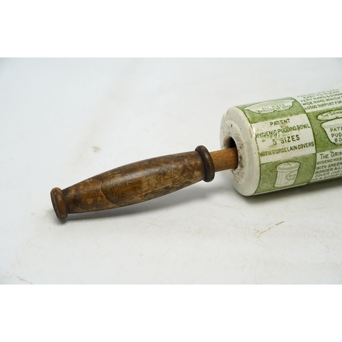 1287 - An early 20th century Grimwades green printed earthenware promotional rolling pin, 47cm wide. Condit... 