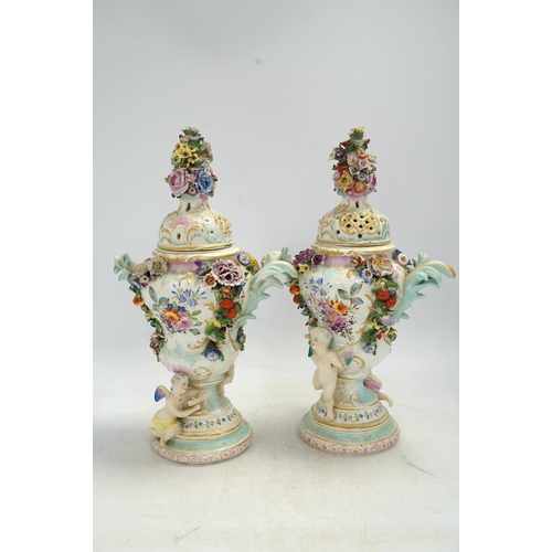 1308 - A pair of Potschappel porcelain floral encrusted vases and covers, 31cm high. Condition - poor... 