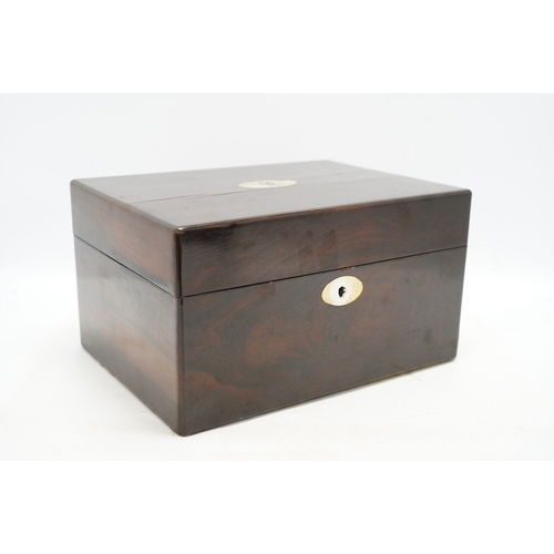 1314 - A Victorian rosewood toilet box with silver plate lidded bottles, âsecretâ draw and leather case... 