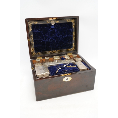 1314 - A Victorian rosewood toilet box with silver plate lidded bottles, âsecretâ draw and leather case... 