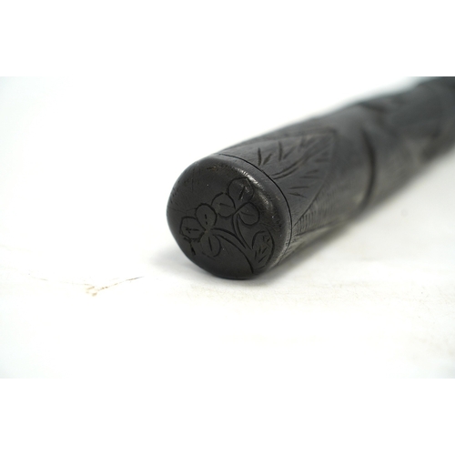 1318 - A late 19th/early 20th century Irish bog oak truncheon, carved with a harp and clovers, 37cm in leng... 