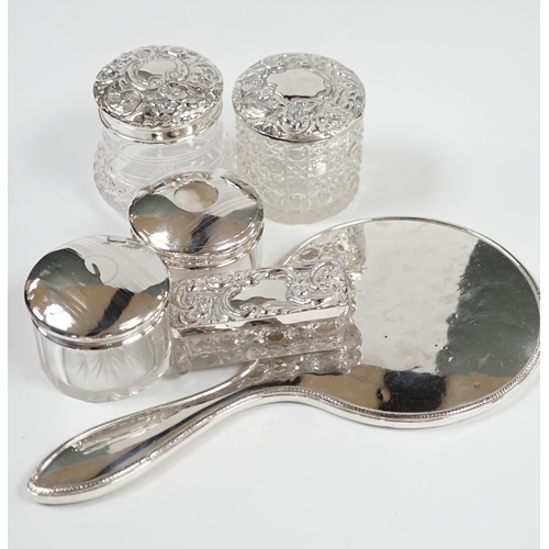 1843 - A silver hand mirror, marks rubbed and five assorted silver mounted glass toilet jars. Condition - p... 