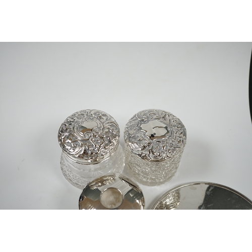 1843 - A silver hand mirror, marks rubbed and five assorted silver mounted glass toilet jars. Condition - p... 