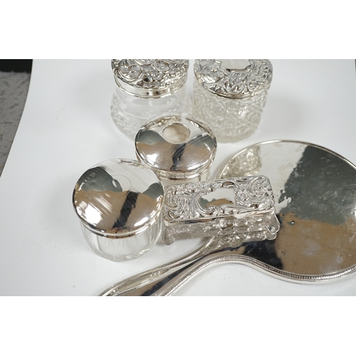 1843 - A silver hand mirror, marks rubbed and five assorted silver mounted glass toilet jars. Condition - p... 