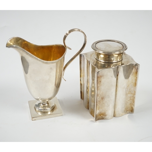 1851 - An Edwardian silver âbats wingâ tea caddy, Birmingham, 1906, 95mm and a George V silver cream ju... 