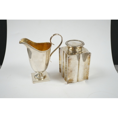 1851 - An Edwardian silver âbats wingâ tea caddy, Birmingham, 1906, 95mm and a George V silver cream ju... 