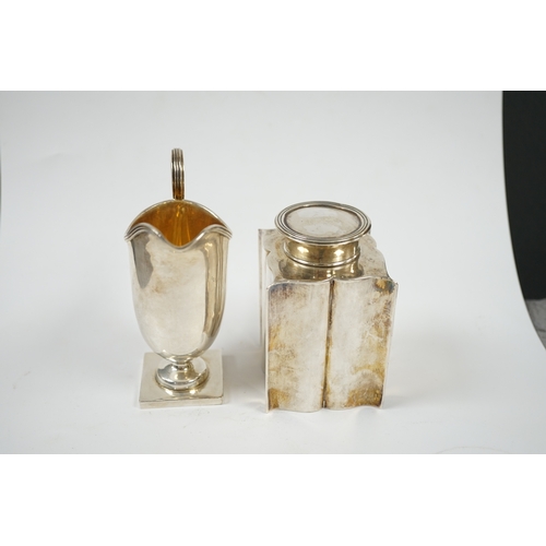 1851 - An Edwardian silver âbats wingâ tea caddy, Birmingham, 1906, 95mm and a George V silver cream ju... 