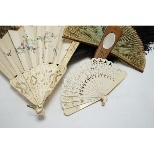 464 - A black ostrich feather and tortoiseshell fan and four others including a carved bone and floral pai... 