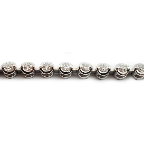 A modern 18ct white gold and diamond set line bracelet, set with forty ...