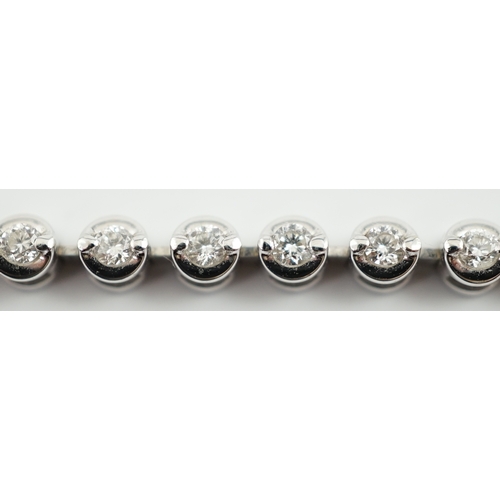 A modern 18ct white gold and diamond set line bracelet, set with forty ...