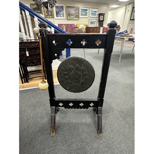 160 - A late Victorian Gothic Revival oak dinner gong with strikers, width 50cm, height 94cm. Condition - ... 