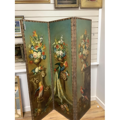 166 - An early 20th century painted canvas three fold dressing screen decorated with parrots among vases o... 