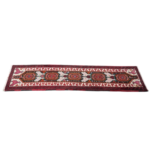 173 - A Turkish red ground geometric runner, 266 x 63cm. Condition - good