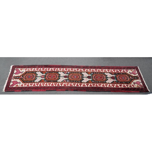 173 - A Turkish red ground geometric runner, 266 x 63cm. Condition - good