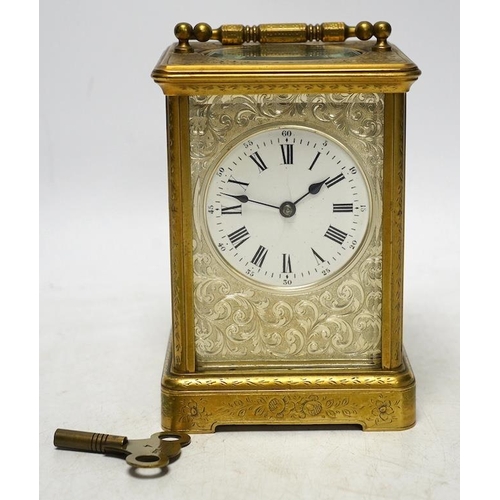 253 - An engraved brass carriage clock by Richard & Cie, serial number 648, with key, 14cm. Condition - fa... 