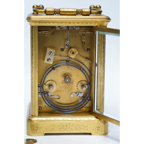 253 - An engraved brass carriage clock by Richard & Cie, serial number 648, with key, 14cm. Condition - fa... 