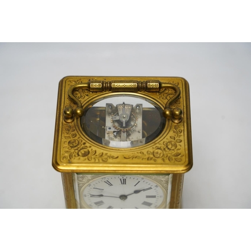 253 - An engraved brass carriage clock by Richard & Cie, serial number 648, with key, 14cm. Condition - fa... 