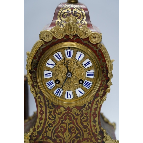 257 - A Louis XV style red boulle eight day mantel clock, with bracket and pendulum, clock 30cm high. Cond... 