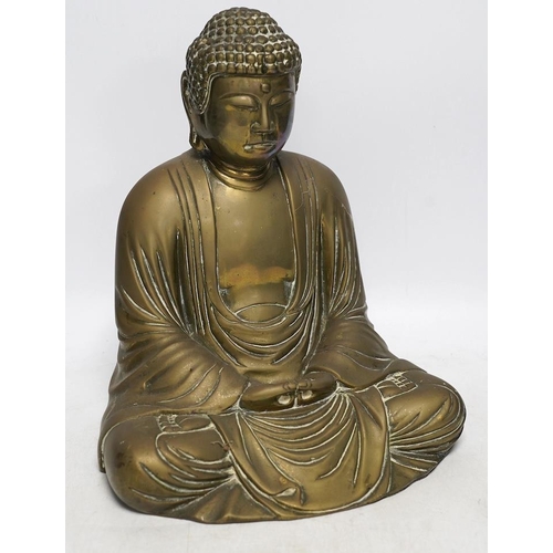 262 - A cast brass figure of Buddha, 27cm high. Condition - fair to good