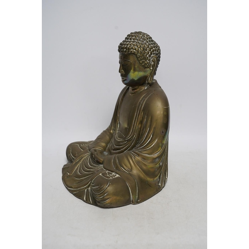 262 - A cast brass figure of Buddha, 27cm high. Condition - fair to good