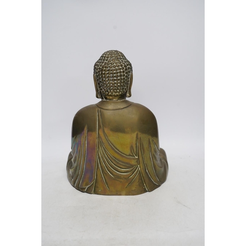 262 - A cast brass figure of Buddha, 27cm high. Condition - fair to good