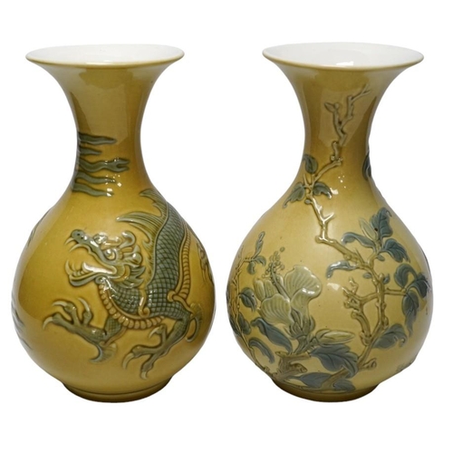 267 - Two Lladro vases decorated in relief with dragons and birds, 26cm high. Condition - good