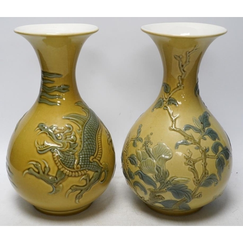 267 - Two Lladro vases decorated in relief with dragons and birds, 26cm high. Condition - good