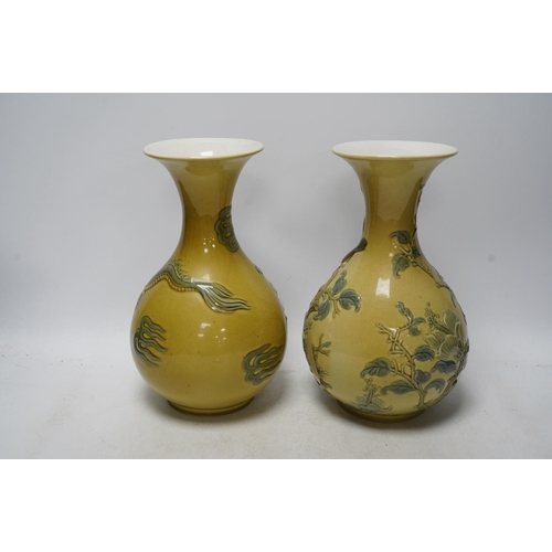 267 - Two Lladro vases decorated in relief with dragons and birds, 26cm high. Condition - good