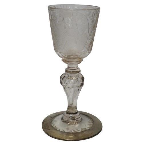 268 - A Victorian engraved tall stemmed wine glass with white metal mounted foot rim, 22cm high. Condition... 