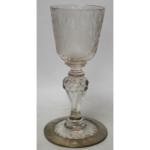 268 - A Victorian engraved tall stemmed wine glass with white metal mounted foot rim, 22cm high. Condition... 