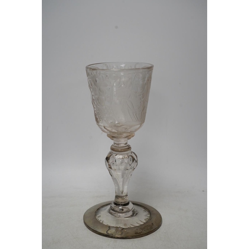 268 - A Victorian engraved tall stemmed wine glass with white metal mounted foot rim, 22cm high. Condition... 