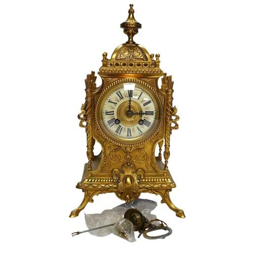 283 - An early 20th century French ormolu mantel clock with key and pendulum, 33cm. Condition - good, not ... 