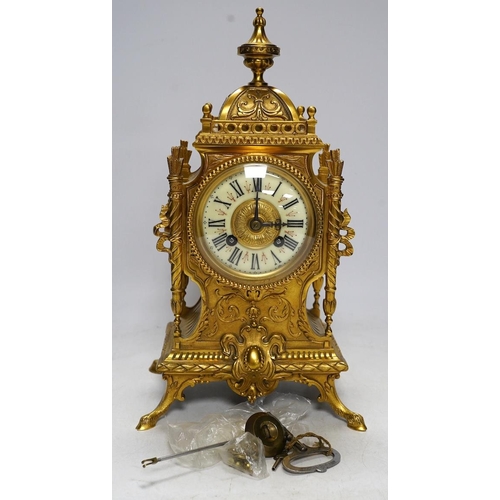 283 - An early 20th century French ormolu mantel clock with key and pendulum, 33cm. Condition - good, not ... 