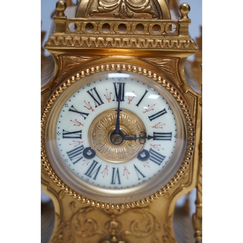 283 - An early 20th century French ormolu mantel clock with key and pendulum, 33cm. Condition - good, not ... 