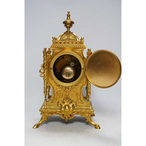 283 - An early 20th century French ormolu mantel clock with key and pendulum, 33cm. Condition - good, not ... 