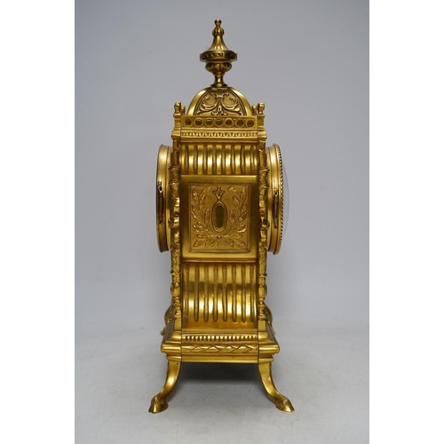 283 - An early 20th century French ormolu mantel clock with key and pendulum, 33cm. Condition - good, not ... 