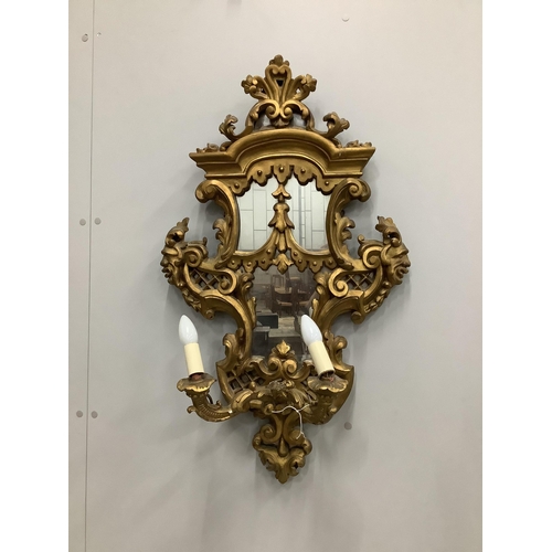 29 - A pair of Italian style carved giltwood and composition two branch girandoles, width 52cm, height 86... 