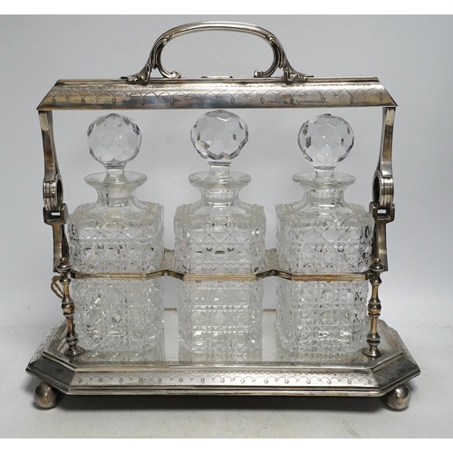 296 - A silver plated three decanter tantalus with unusual duo swing handle locking mechanism, with key, 3... 