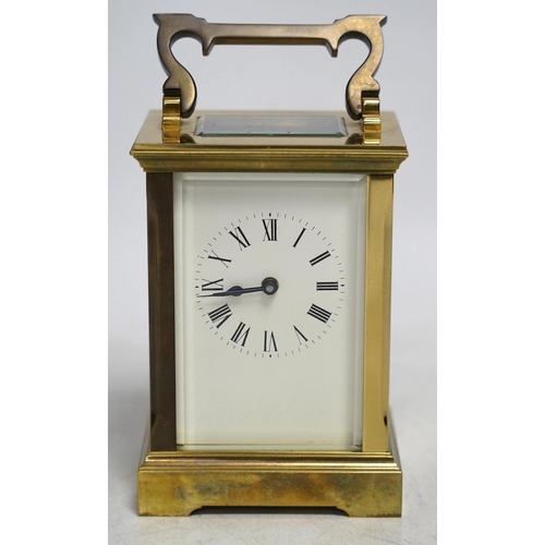 327 - A carriage timepiece with white enamelled Roman dial, in a gilt brass and glazed case, 13cm. Conditi... 