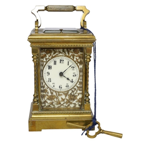 347 - A large brass repeating carriage clock with key and ornate filigree dial, 17cm high (including handl... 