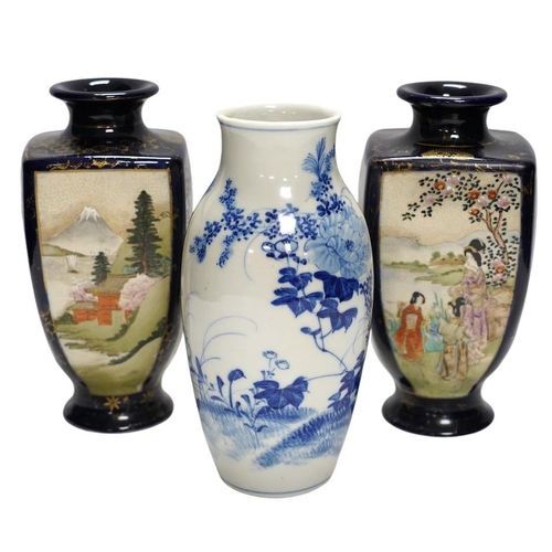 367 - A pair of Japanese satsuma pottery vases and a blue and white Meiji Arita vase, largest 24cm high. C... 