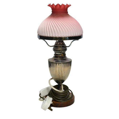 374 - A silver plated table lamp, with a pink satin glass wrythen fluted shade, 41cm high. Condition - sha... 