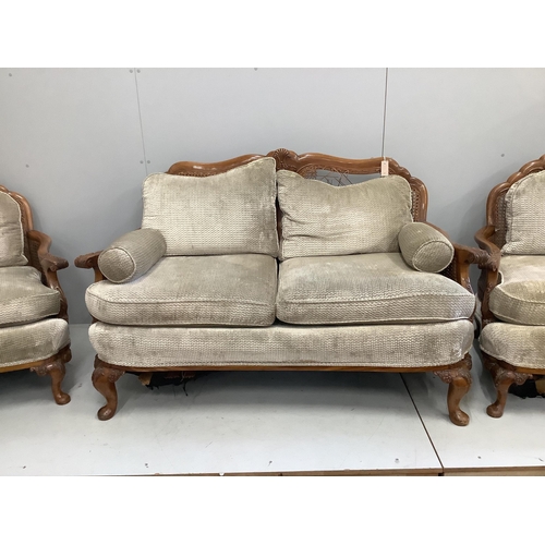 43 - A Queen Anne Revival walnut three piece Bergere suite, cane in need of extensive repair, settee widt... 