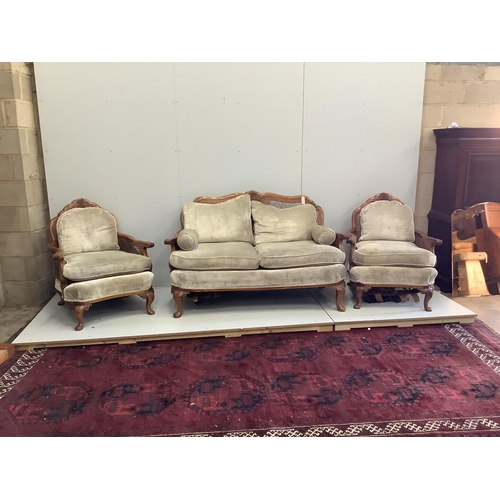 43 - A Queen Anne Revival walnut three piece Bergere suite, cane in need of extensive repair, settee widt... 