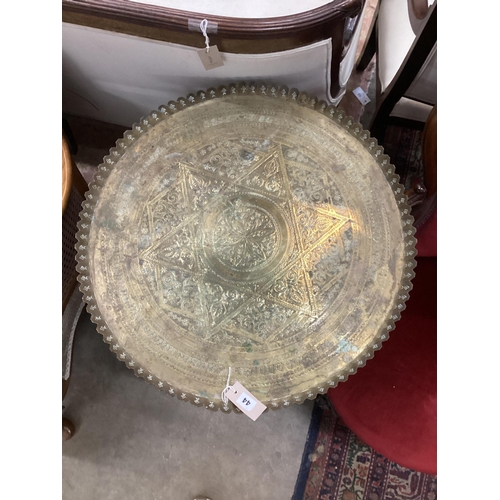 44 - An early 20th century circular engraved brass tray top table on folding bamboo stand, diameter 64cm,... 