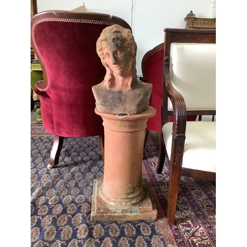 46 - A weathered terracotta garden bust on circular plinth, height 93cm. Condition - fair