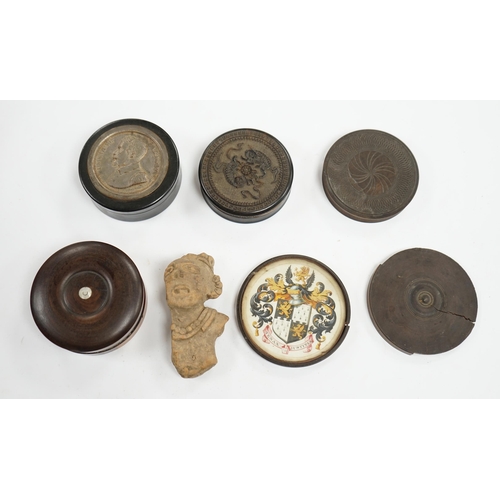 502 - A carved wood case containing armorial crest, Tenax Justitiae, four other circular boxes and a porta... 